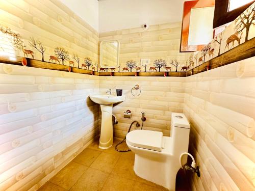 a bathroom with a toilet and a sink at Malgudi House - Commandant in Mysore