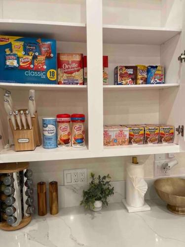 a kitchen counter with shelves filled with food at Luxury Disneyland Home: Family & Exec Friendly in Anaheim