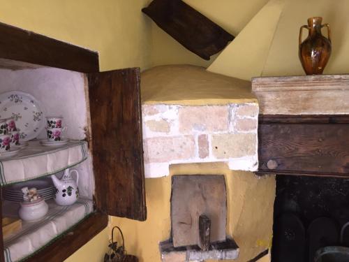 a room with a brick fireplace in a room at Casa Gavenniae in Nocciano