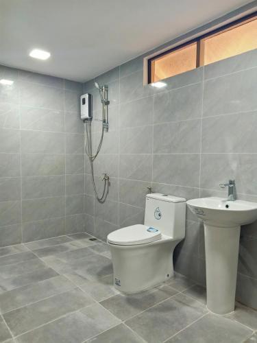 a bathroom with a toilet and a sink at Panglao Kalikasan Resort in Panglao Island
