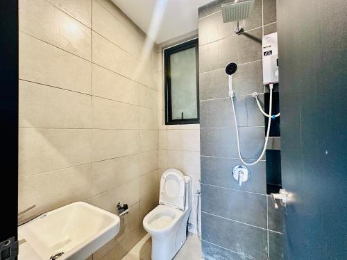 a small bathroom with a toilet and a sink at Cozy & Drive Urban Suite by WL in Jelutong