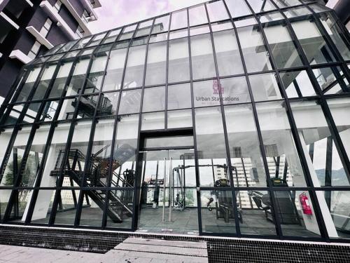 a large glass building with a sign on it at Cozy & Drive Urban Suite by WL in Jelutong