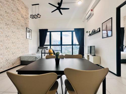 a dining room with a table and chairs and a bedroom at Cozy & Drive Urban Suite by WL in Jelutong