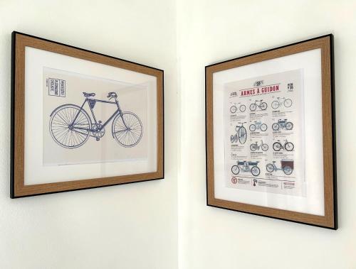 a framed picture of a bike on a wall at Villa K'nell - La Possession in La Possession