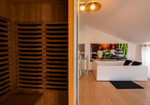 a living room with a wine cellar and a kitchen at Wellness Villa Istriana in Umag