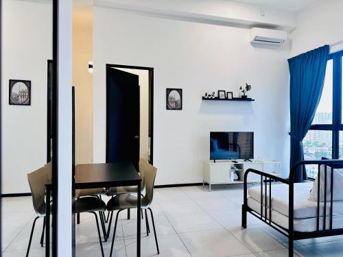 a bedroom with a desk and a bed and a table at Cozy & Drive Urban Suite by WL in Jelutong