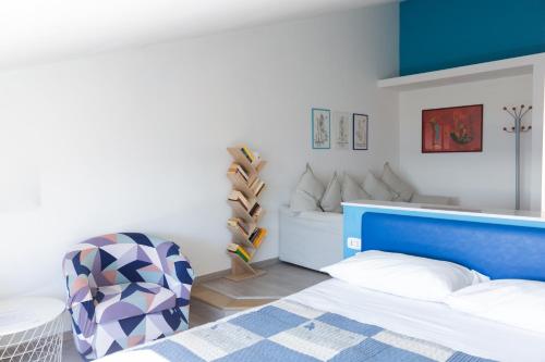a bedroom with a blue bed and a chair at Palazzo Mirelli in Naples