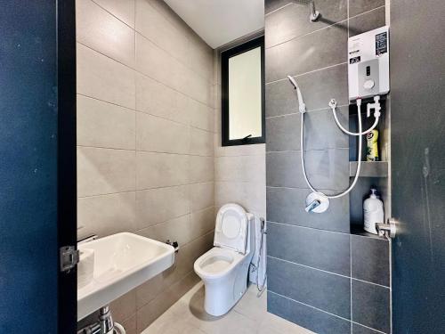 a small bathroom with a toilet and a sink at Cozy & Drive Urban Suite by WL in Jelutong