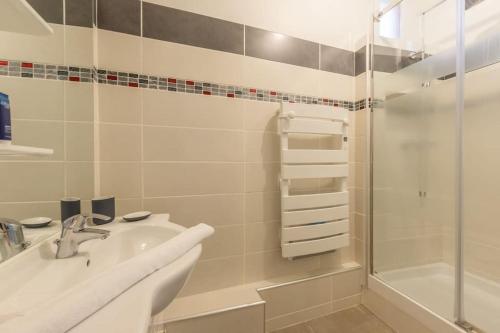 une salle de bain blanche avec un lavabo et une douche dans l'établissement Appartement moderne et lumineux- Montpellier centre, à Montpellier