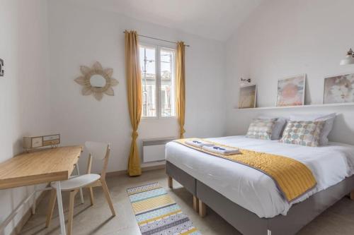 une chambre avec un lit, un bureau et une fenêtre dans l'établissement Appartement moderne et lumineux- Montpellier centre, à Montpellier