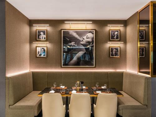 a dining room with a table and chairs at Rixos Gulf Hotel Doha in Doha