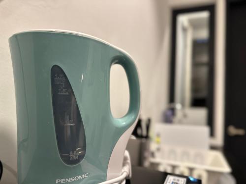 a green and white toaster sitting on a counter at Cozy & Drive Urban Suite by WL in Jelutong