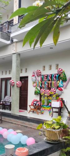 a building with candy canes on the side of it at Pujihouse One in Legian