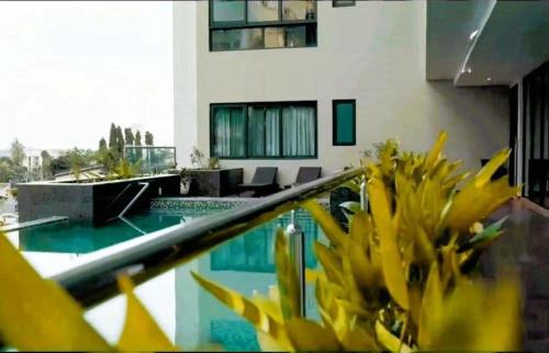 a view of a swimming pool from the balcony of a building at Primahem solaris in Accra