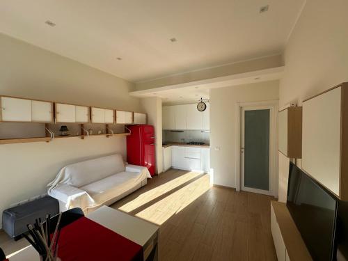 a living room with a couch and a red refrigerator at Appartamento Katy in Viareggio