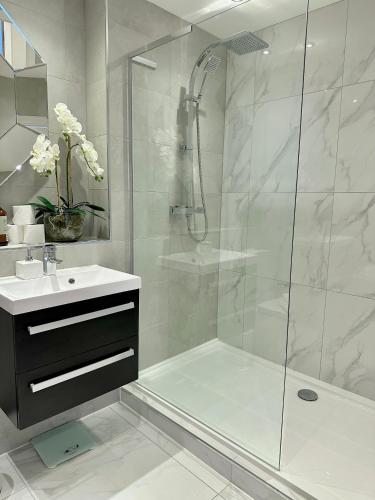 a bathroom with a shower and a sink at Superior Apartment In Cardiff City Centre in Cardiff