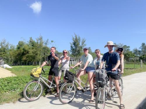 a group of people on bikes on a path at Dreamers Farm in Vinh Thanh