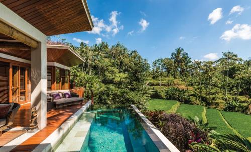 a swimming pool in the backyard of a villa at Four Seasons Resort Bali at Sayan in Ubud