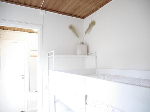 a white room with white shelves and a window at Cozy Hilltop Cottage With Fantastic View in Undenäs