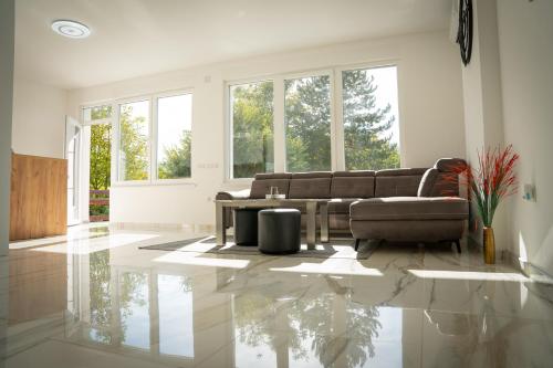 a living room with a couch and a table at Apartment Una Laguna in Bihać