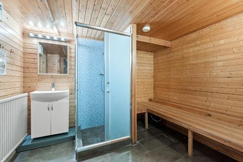 a wooden bathroom with a shower and a sink at Venture Vacations-Massive Villa in Downtown Reykjavík with a Sauna in Reykjavík