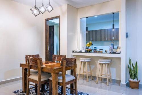 a dining room with a wooden table and chairs at Sophie's World- 2 Bedroom luxury apartment in Lubowa