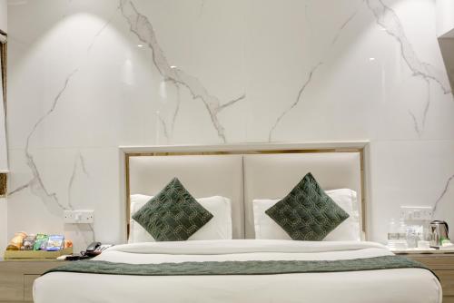 a bedroom with a large white bed with two pillows at Hotel International Inn - Near Delhi Airport in New Delhi