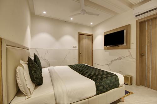 a bedroom with a large bed and a television at Hotel International Inn - Near Delhi Airport in New Delhi