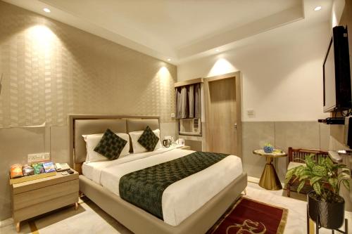 a hotel room with a bed and a television at Hotel International Inn - Near Delhi Airport in New Delhi