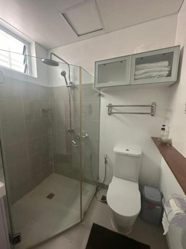 a bathroom with a glass shower and a toilet at Pico De Loro staycation in Nasugbu