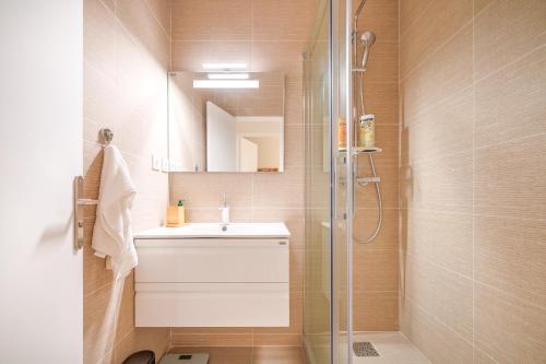 a bathroom with a sink and a shower at Spacious apartments for 6 people #3 in Asnières-sur-Seine