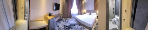 En eller flere senger på et rom på Homy House Hotel