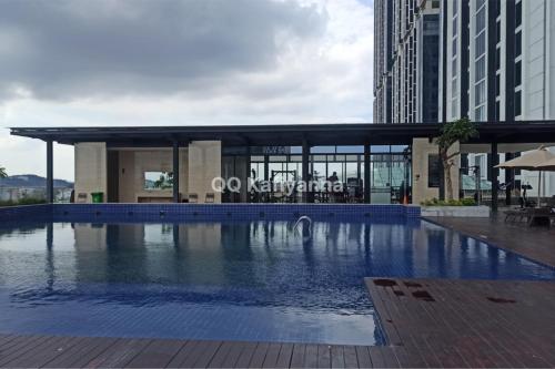 a swimming pool in front of a building at Apartment Meisterstadt Pollux Habibie Studio Sea View A1-2112 - Netflix Premium in Batam Center
