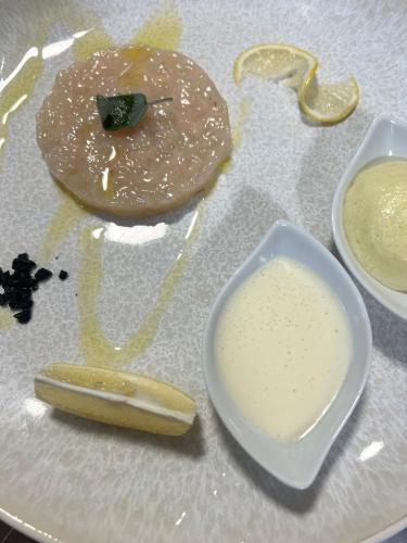 a plate with a donut and a bowl of sauce at Wellness Villa Istriana in Umag