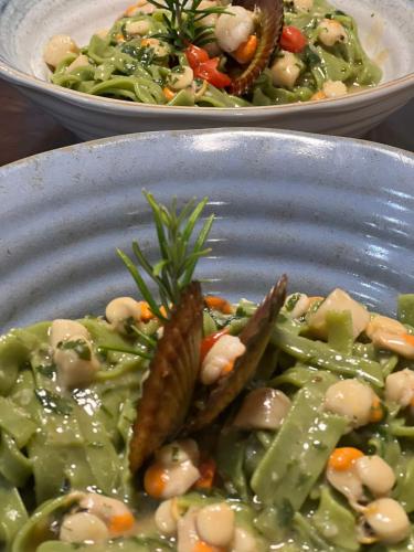 two bowls of food with peas and carrots and vegetables at Wellness Villa Istriana in Umag