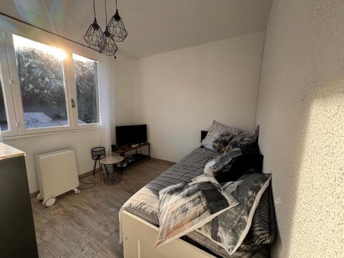 une petite chambre avec un lit et une télévision dans l'établissement Studio Rennes les bains au pied des Thermes, à Rennes-les-Bains