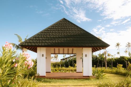 a gazebo with a black roof at Joy Island Maldives All Inclusive Resort in Male City