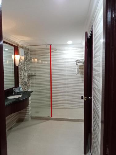 a bathroom with a glass shower with a sink at BBS APARTMENT AT TIMES SQUARE KUALA LUMPUR MALAYSIA in Kuala Lumpur