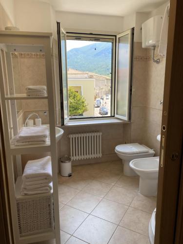 a bathroom with a toilet and a sink and a window at Terrazza su Tocco in Tocco da Casauria