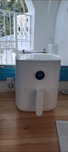 a white food processor sitting on top of a wooden floor at Final step in Skiathos Town