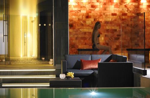 a woman is sitting on a wall in a room at Westport Coast Hotel in Westport