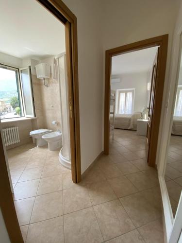 a large bathroom with two toilets and a sink at Terrazza su Tocco in Tocco da Casauria
