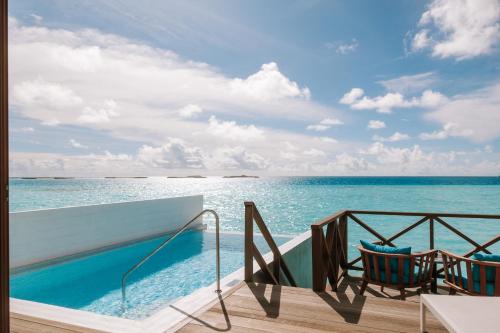 a view of the ocean from the balcony of a resort at Joy Island Maldives All Inclusive Resort in Male City
