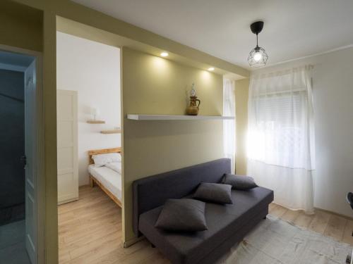 a living room with a couch and a bed at MDC Apartments in Timişoara