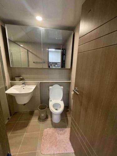 a small bathroom with a toilet and a sink at (NEW) Luxury Condo in Clark 