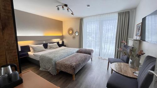 a hotel room with a bed and a table at Harz hotel Iris in Sieber