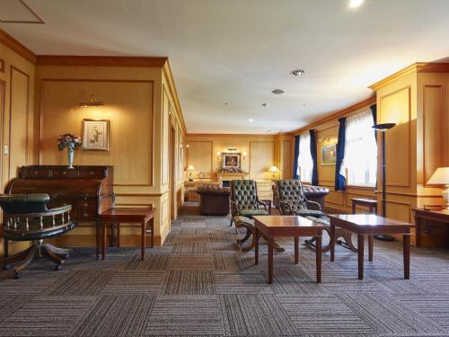 a living room with furniture and a piano at Wellness Forest Nasu in Nasu