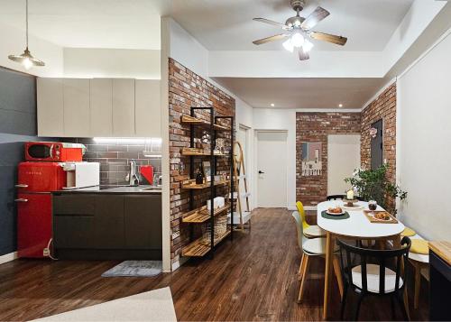 a kitchen and dining room with a table and a refrigerator at Brick stay in Seoul