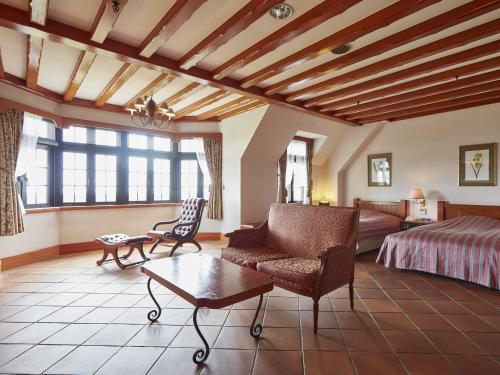 a bedroom with a bed and a couch and a table at Wellness Forest Nasu in Nasu