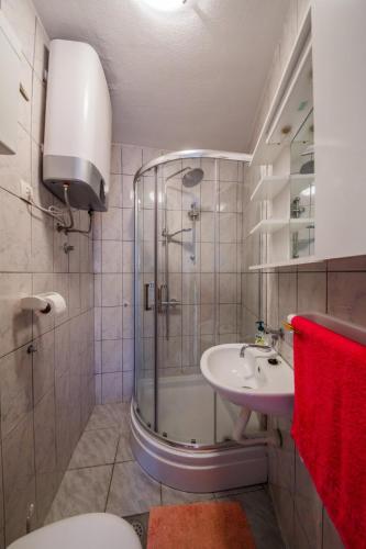 a bathroom with a shower and a sink at Stone House Kaštela in Kaštela